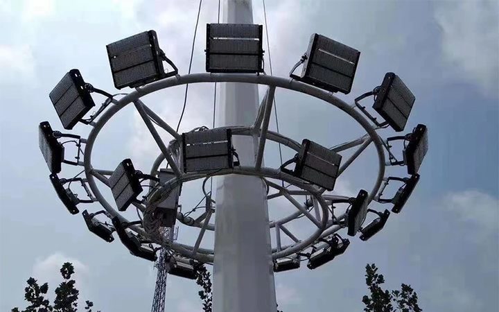 Multiple floodlights mounted around a high-mast structure